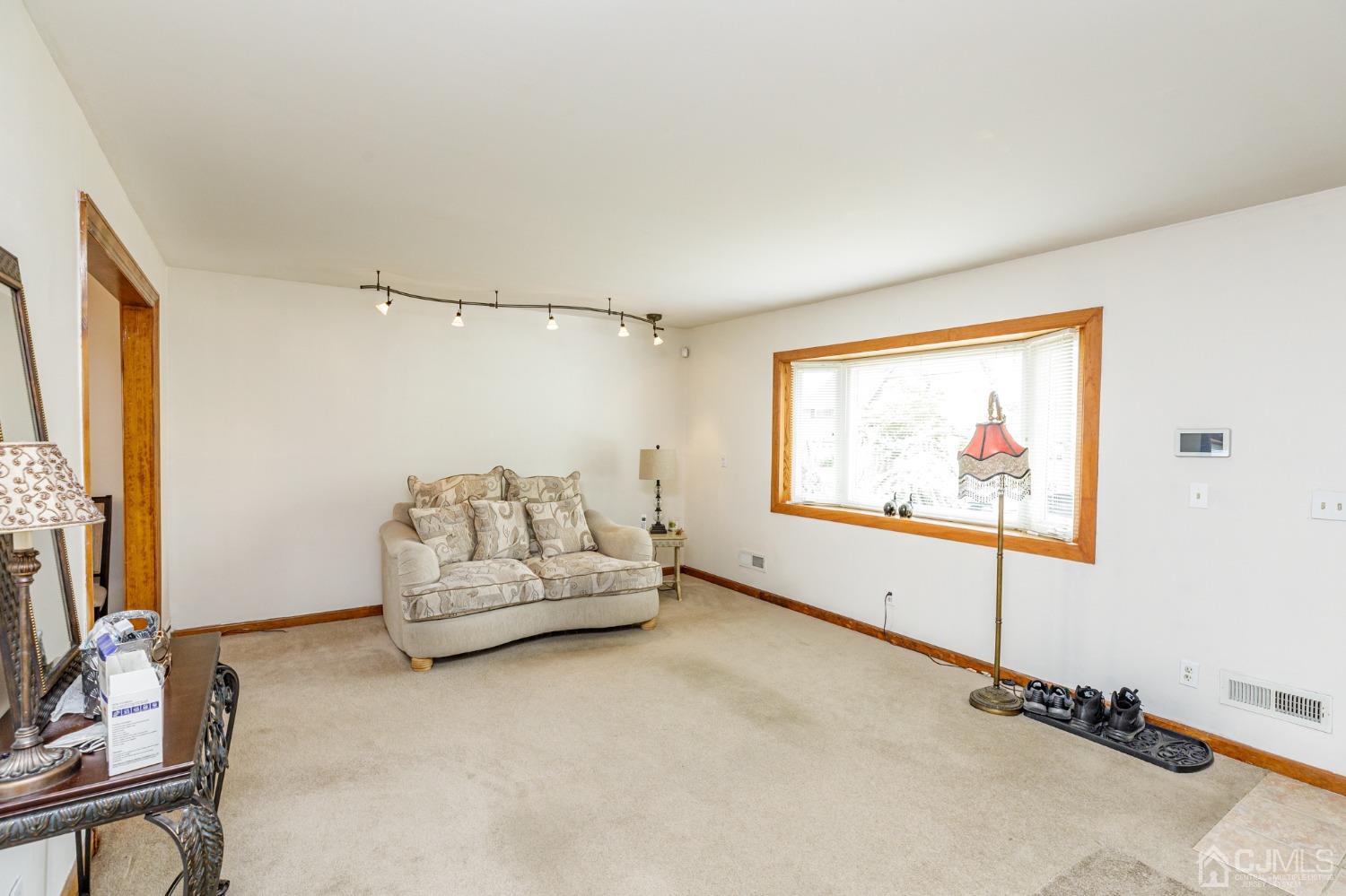 2761 Hickory Road Union, NJ 07083 - Photo 2 of 30 a living room with furniture a flat screen tv and a wall painting