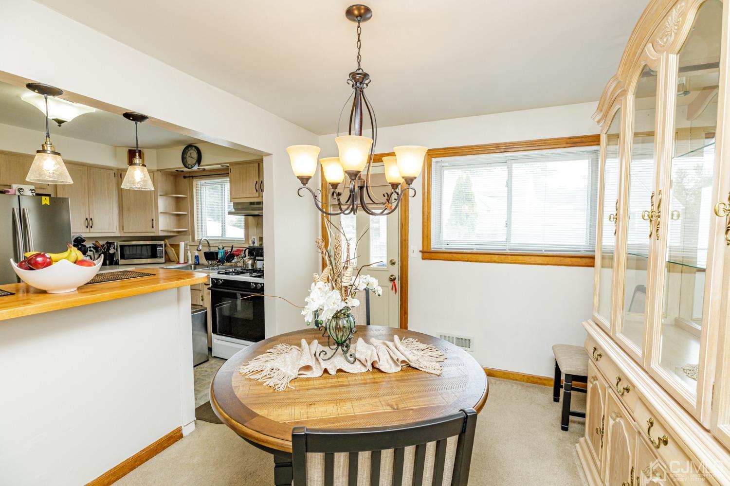 2761 Hickory Road Union, NJ 07083 - Photo 5 of 30 a dining room with stainless steel appliances granite countertop a sink and a chandelier