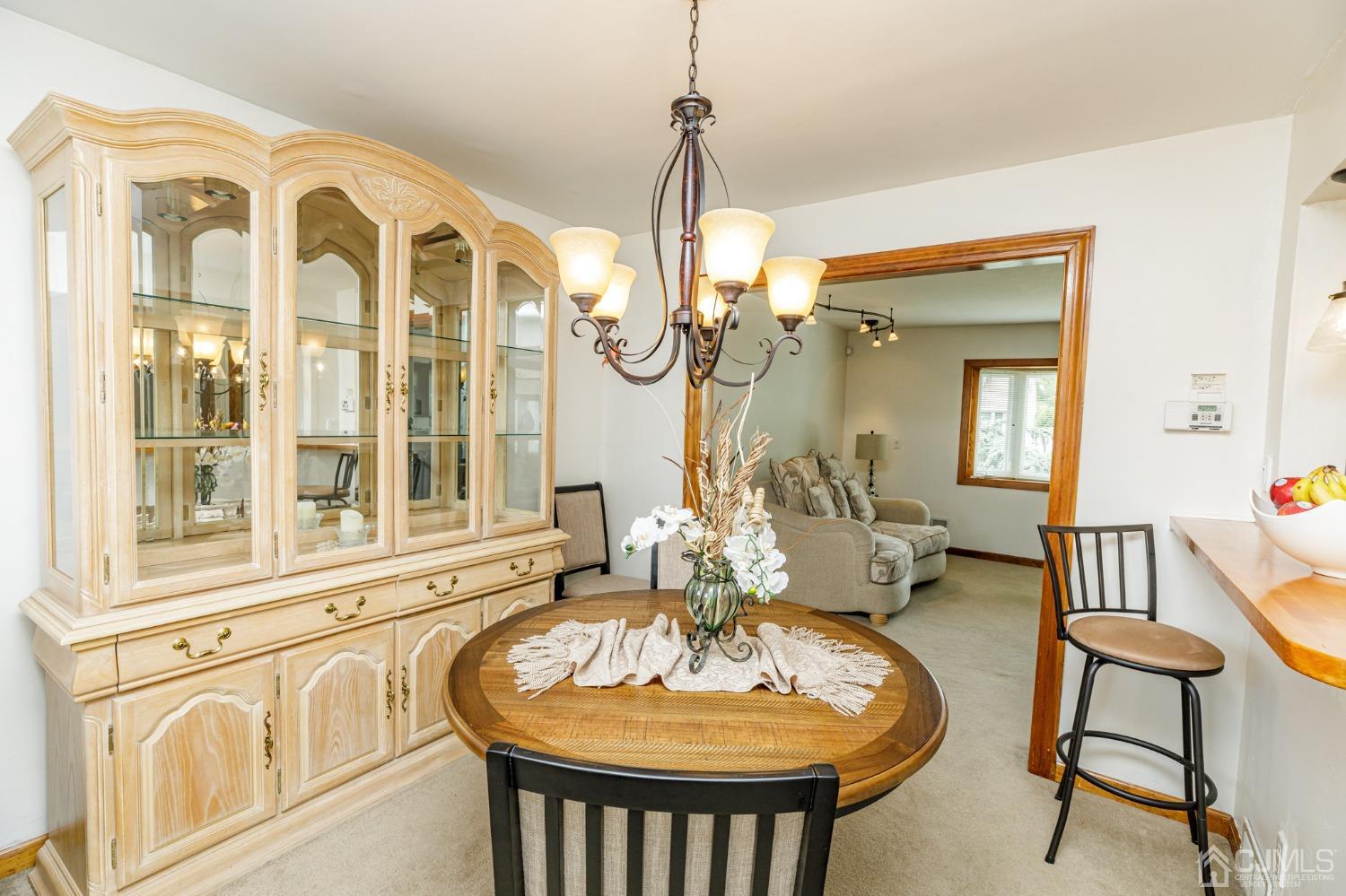2761 Hickory Road Union, NJ 07083 - Photo 6 of 30 a dining room with furniture a chandelier and wooden floor