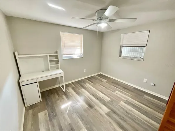 a view of a room with wooden floor and white walls