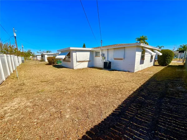 a yellow house with a yard