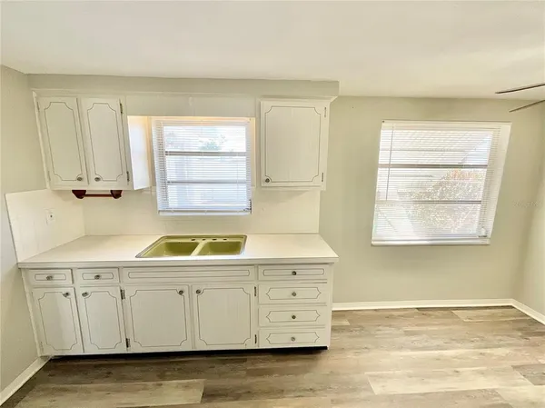 a view of cabinets a sink and a window