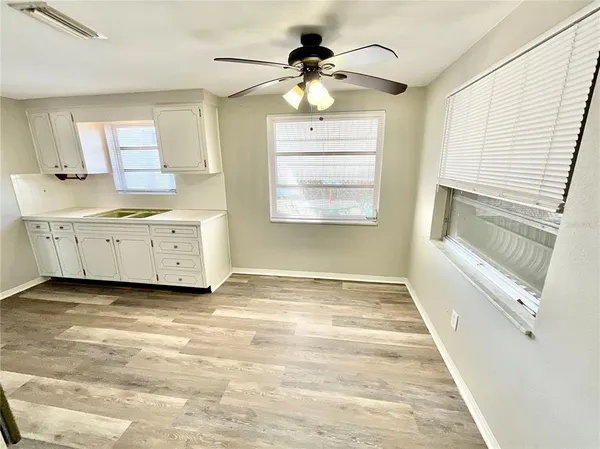 a view of a kitchen with a sink hardwood floor and a living room