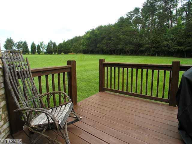 7774 Sutter Road Greensboro, NC 27455 - Photo 15 of 16 View. .70 acre flat lot with trees and walkway behind property
