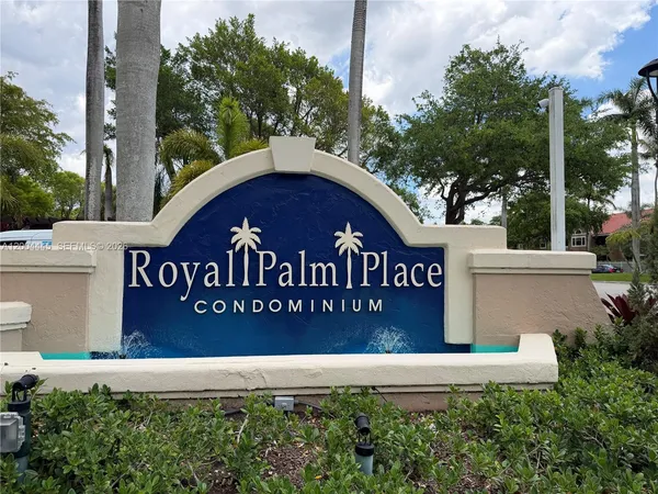 a sign of a park next to a road