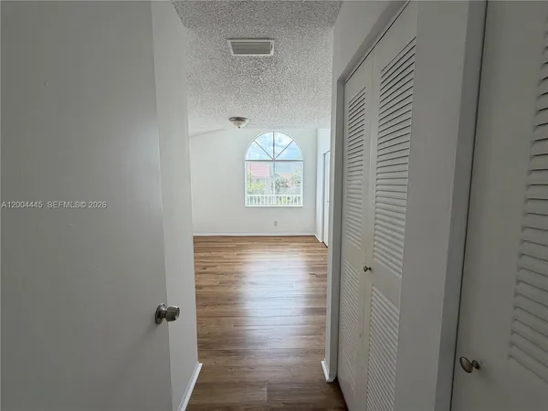 a view of a hallway with front door