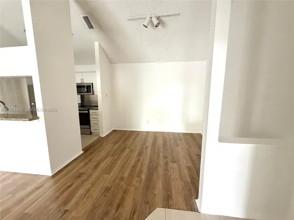 a view of a kitchen from the hallway