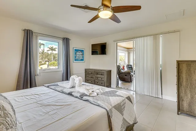 a bedroom with a bed and a television