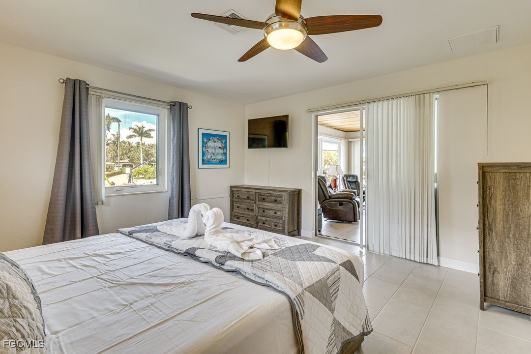 15340 River By Road Fort Myers, FL 33908 - Photo 12 of 21 a bedroom with a bed and a television