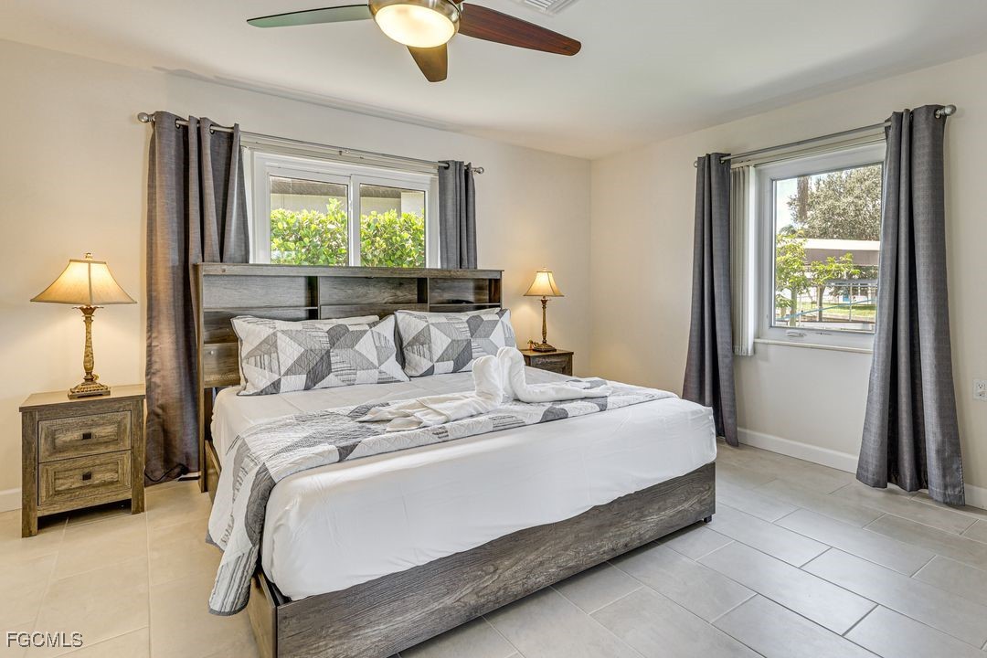 15340 River By Road Fort Myers, FL 33908 - Photo 14 of 21 a large bed sitting in a bedroom next to a window