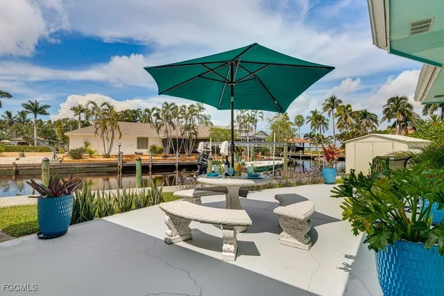 a view of a lake with couches and umbrella
