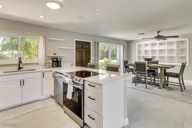 a kitchen with a stove a sink and a refrigerator