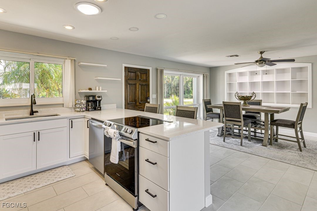 15340 River By Road Fort Myers, FL 33908 - Photo 3 of 21 a kitchen with a stove a sink and a refrigerator
