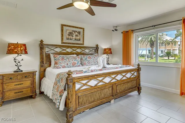 a bed sitting in a bedroom next to a window