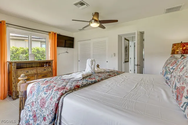 a bedroom with a large bed and a window