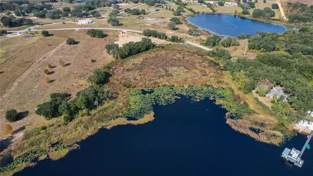 an aerial view of a house yard and lake view