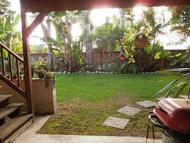 a view of a chair and table in the garden