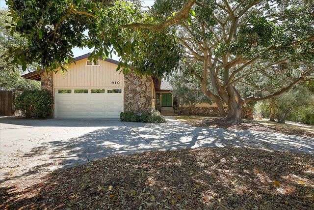 a view of a tree in front of a house