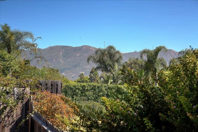 a view of a house with a mountain in the background