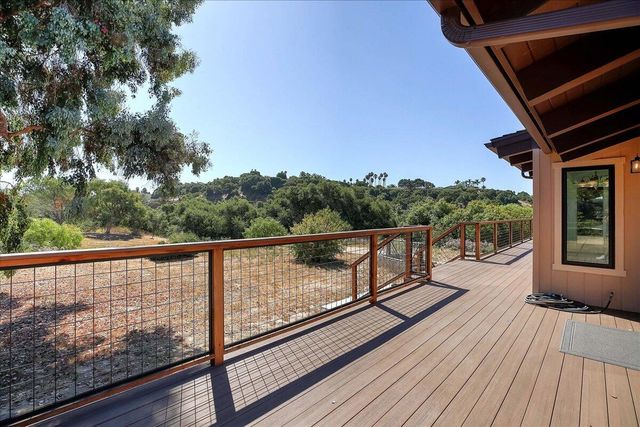 a view of balcony with wooden floor and fence
