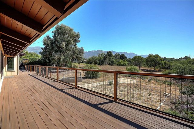 a view of balcony with wooden floor
