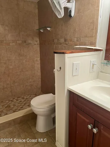 a bathroom with a sink a toilet and a shower
