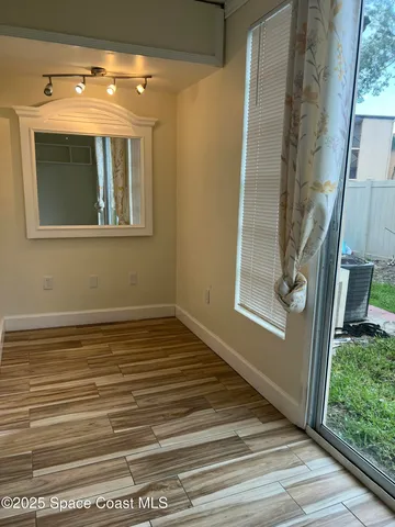 a view of a yard with plants and trees