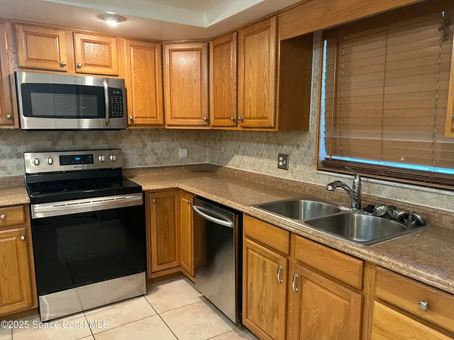 a kitchen with stainless steel appliances granite countertop a sink and a microwave