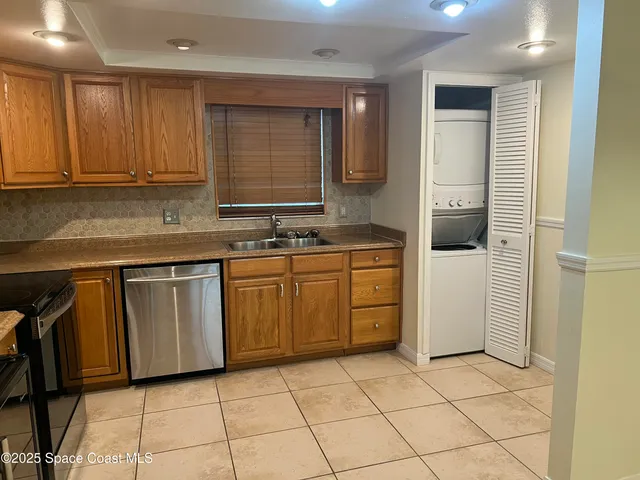 a kitchen with a sink window and cabinets