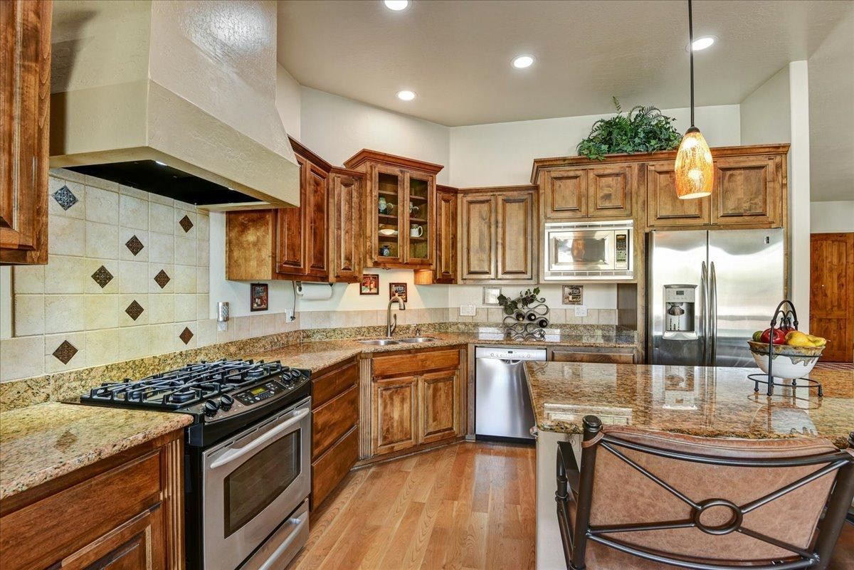412 East Yearling Road Phoenix, AZ 85085 - Photo 13 of 51 a kitchen with stainless steel appliances granite countertop a stove a sink and a microwave