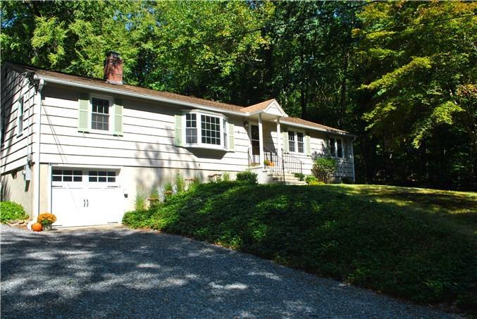 57 Old Mill Road Weston, CT 06883 - Photo 1 of 1 a front view of a house with a yard and garage
