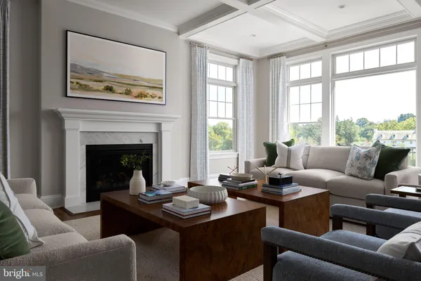 a living room with furniture two window and a fireplace