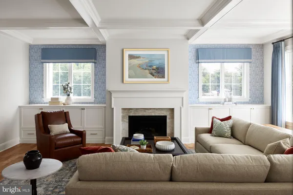 a living room with furniture a large window and a fireplace