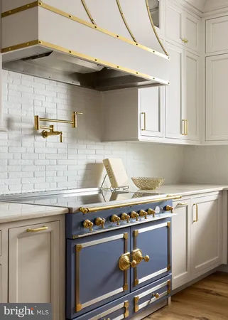 a stove top oven sitting inside of a kitchen