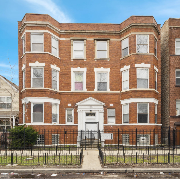 1453 South Springfield Avenue Chicago, IL 60623 - Photo 1 of 13 a front view of a residential apartment building with a yard