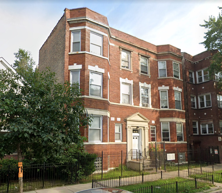 1453 South Springfield Avenue Chicago, IL 60623 - Photo 2 of 13 a front view of a residential apartment building with a yard