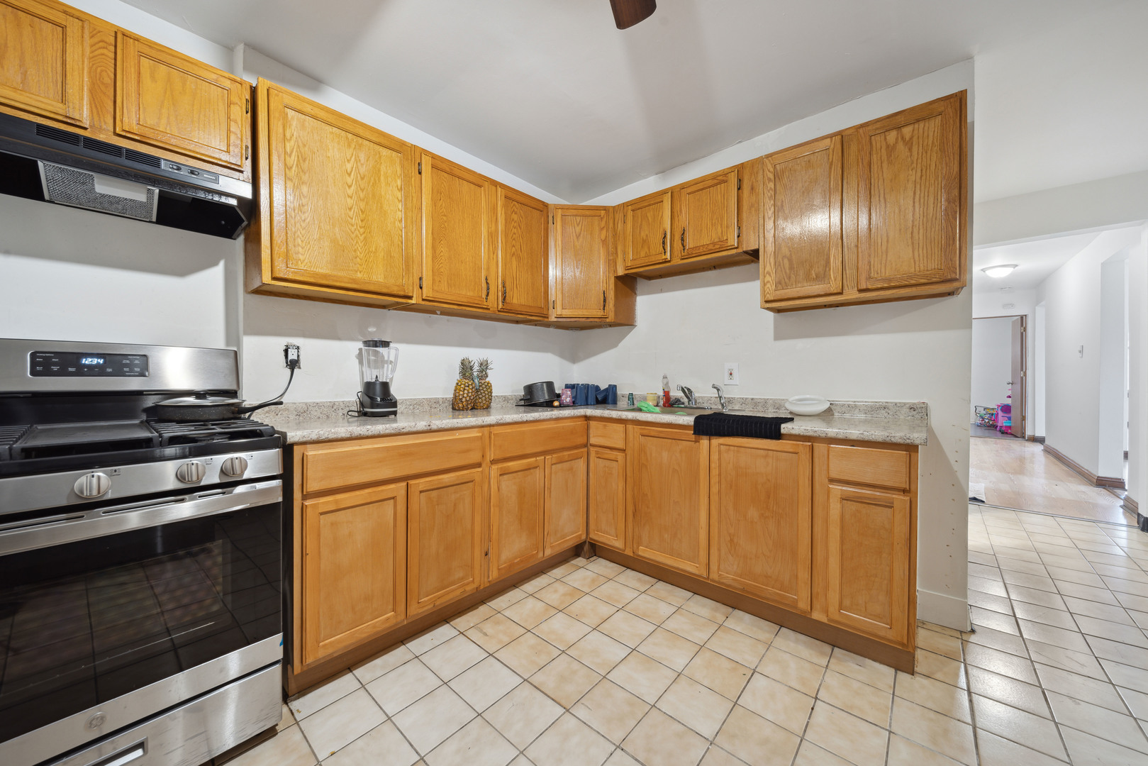 1453 South Springfield Avenue Chicago, IL 60623 - Photo 5 of 13 a kitchen with granite countertop cabinets stainless steel appliances and a sink