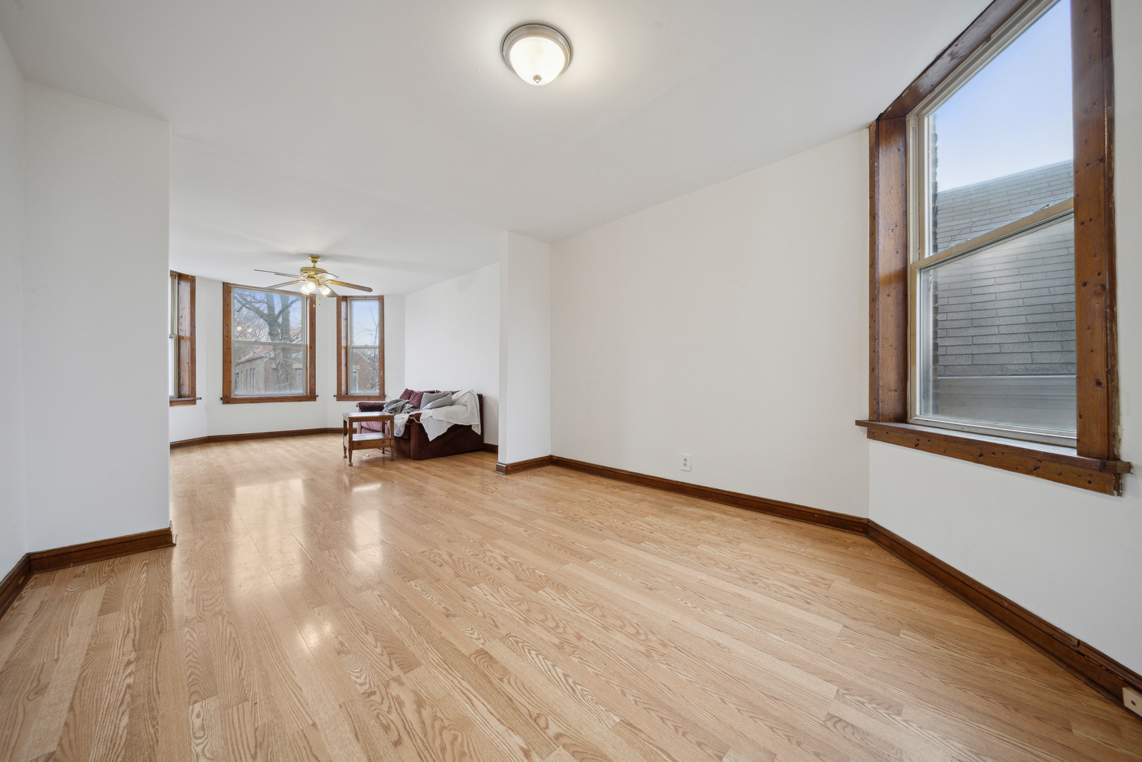 1453 South Springfield Avenue Chicago, IL 60623 - Photo 7 of 13 a view of a livingroom with a flat screen tv wooden floor and a window
