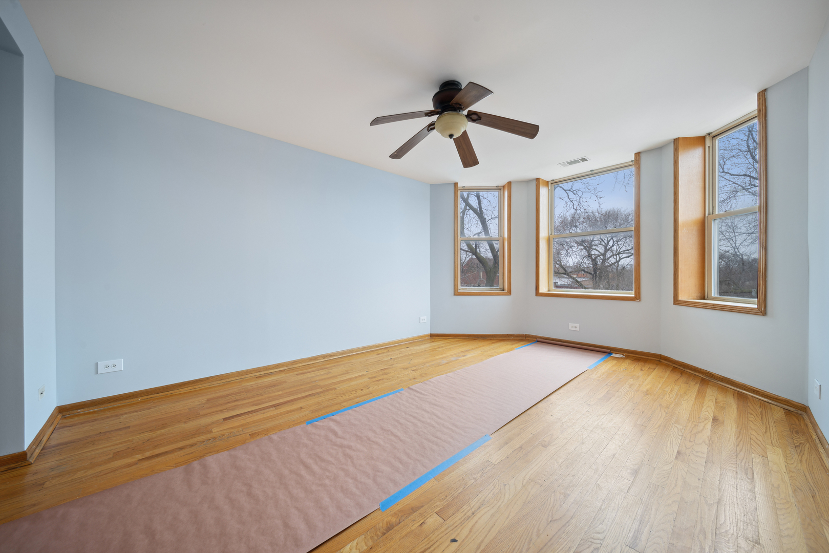 1453 South Springfield Avenue Chicago, IL 60623 - Photo 9 of 13 a view of empty room with wooden floor and fan