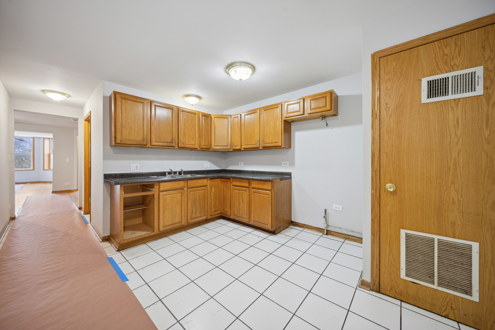 1453 South Springfield Avenue Chicago, IL 60623 - Photo 10 of 13 a kitchen with a stove a sink and a refrigerator