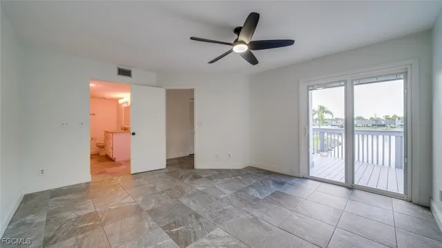 a view of a livingroom with a ceiling fan and window