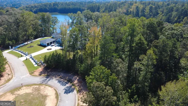 an aerial view of a house with a yard