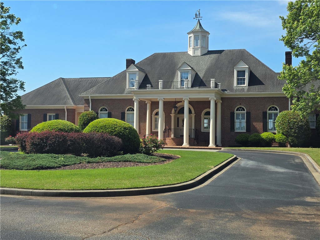 0 Turnberry Loop Seneca, SC 29678 - Photo 8 of 16 This grand brick clubhouse features a welcoming portico and dormers. windows, exuding classic architectural charm.