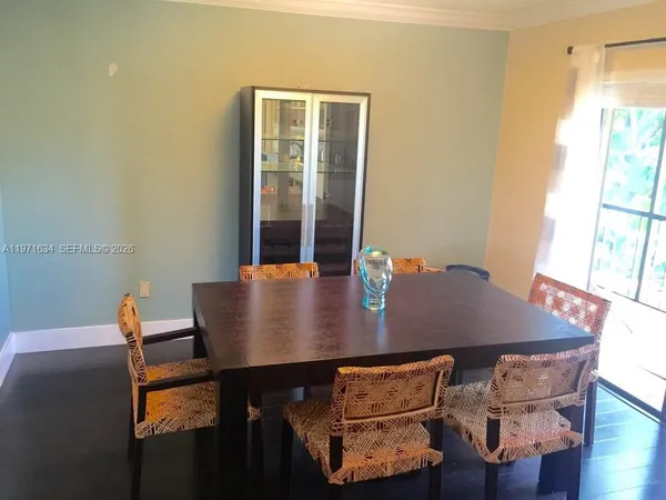 a view of a dining room with furniture and wooden floor
