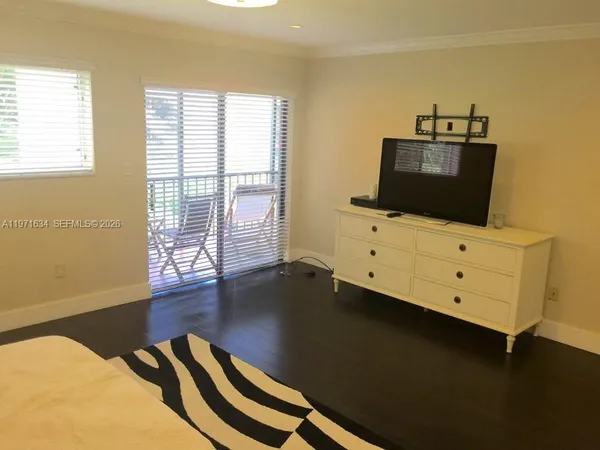a living room with furniture and flat screen tv