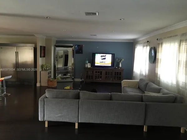 a living room with furniture and a large window