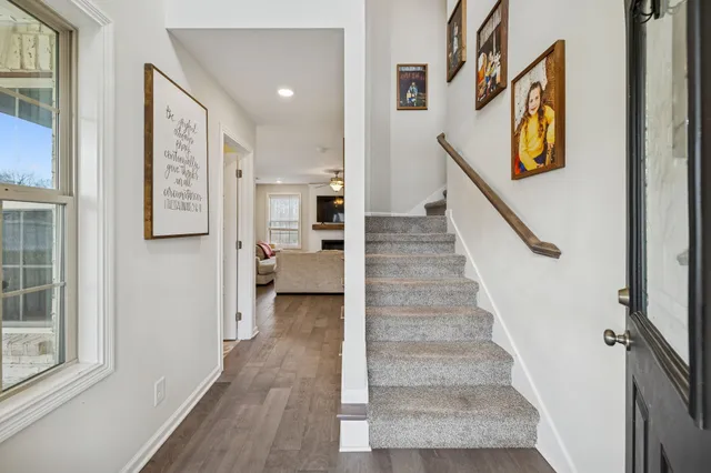 a view of an entryway with wooden floor and stairs