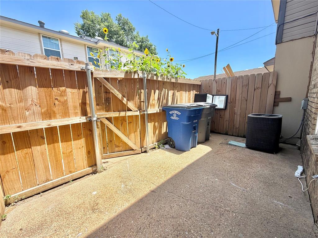 8001 Rothington Road, Unit 33 Dallas, TX 75227 - Photo 15 of 15 Private outdoor space featuring a wood fence, concrete ground, and a small gate