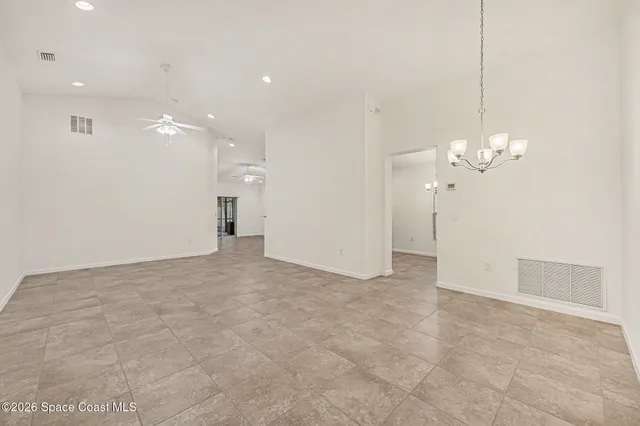 a view of a chandelier fan and a refrigerator