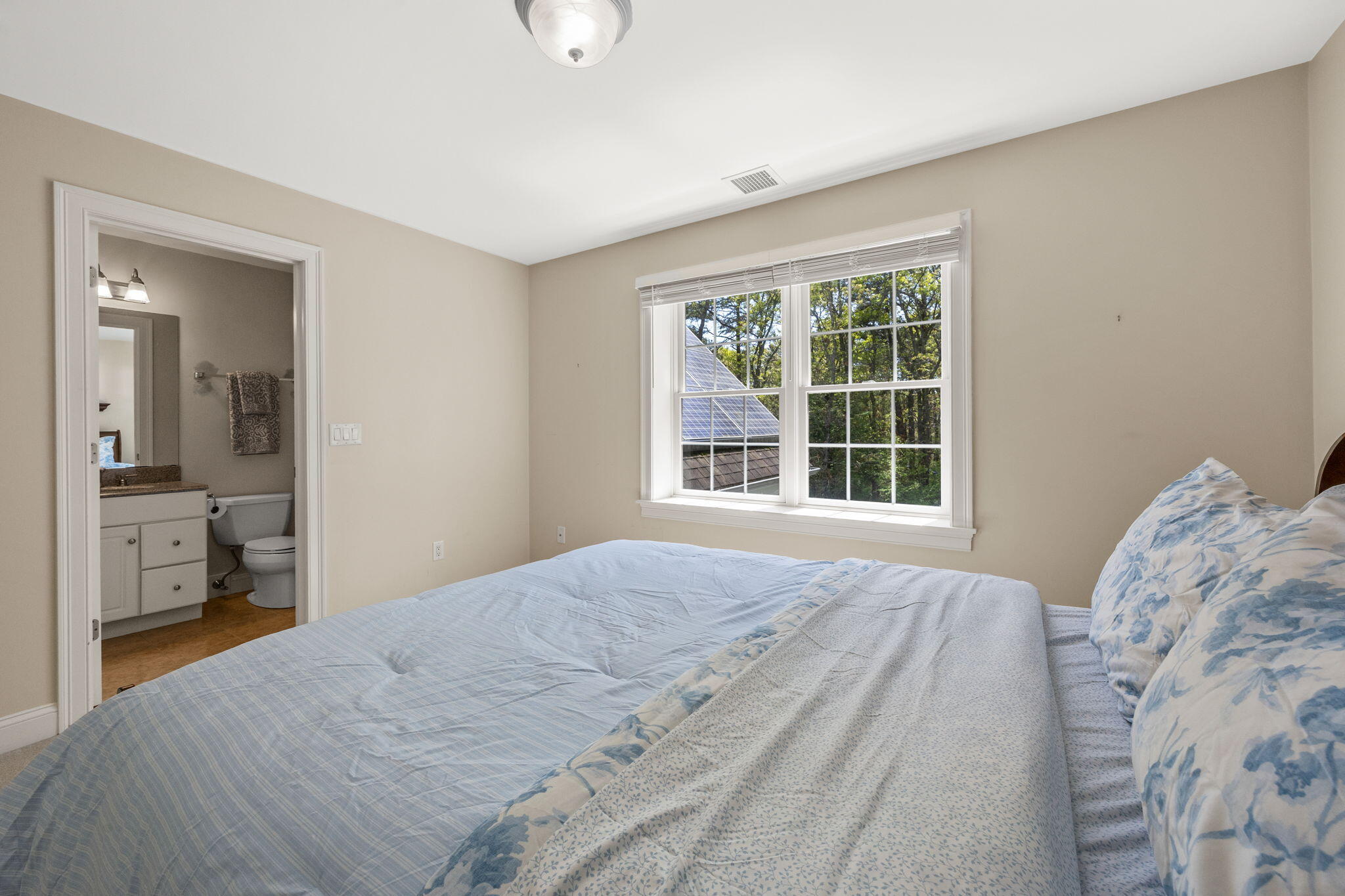 17 Payamps Road Mashpee, MA 02649 - Photo 48 of 72 a bedroom with a bed and a large window